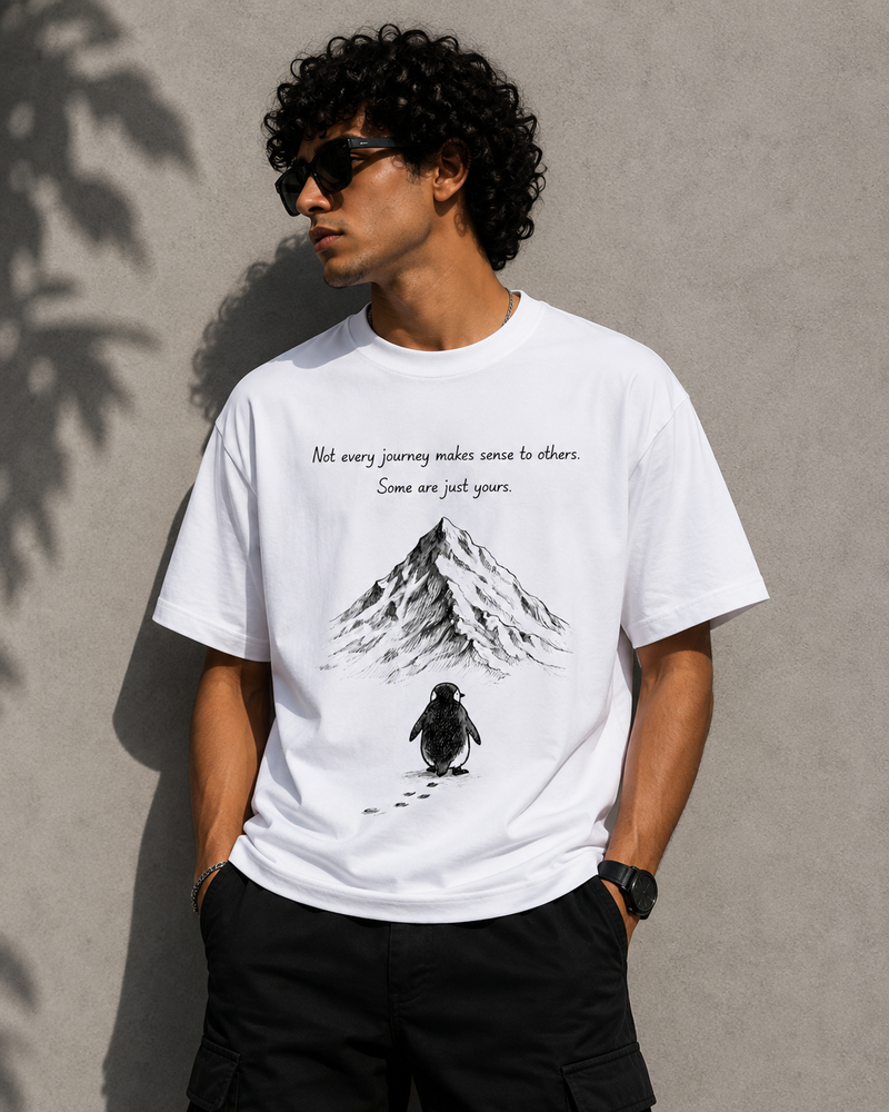 RAVYNN Oversized White T-Shirt – "Not Every Journey" Penguin & Mountain Graphic