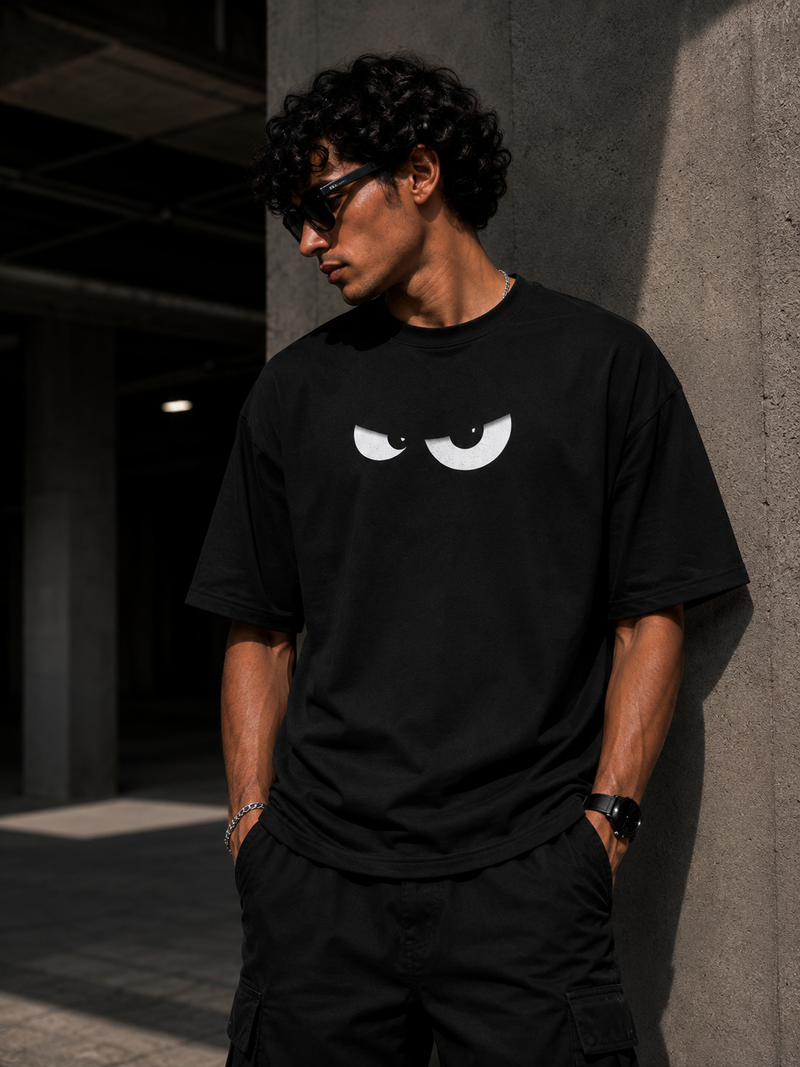 RAVYNN Oversized Black T-Shirt – White Angry Cartoon Eyes Graphic